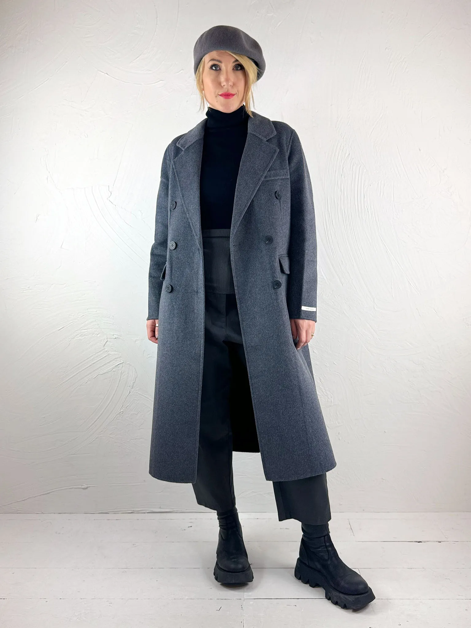 Certainly! To optimize the title for an e-commerce product, its important to include relevant keywords that potential buyers might use when searching, as well as appealing descriptive terms. Here is an optimized title for the Sunny Studio Lou Coat:

Elegant Womens Lou Coat by Sunny Studio – Warm, Stylish, and Versatile Outerwear