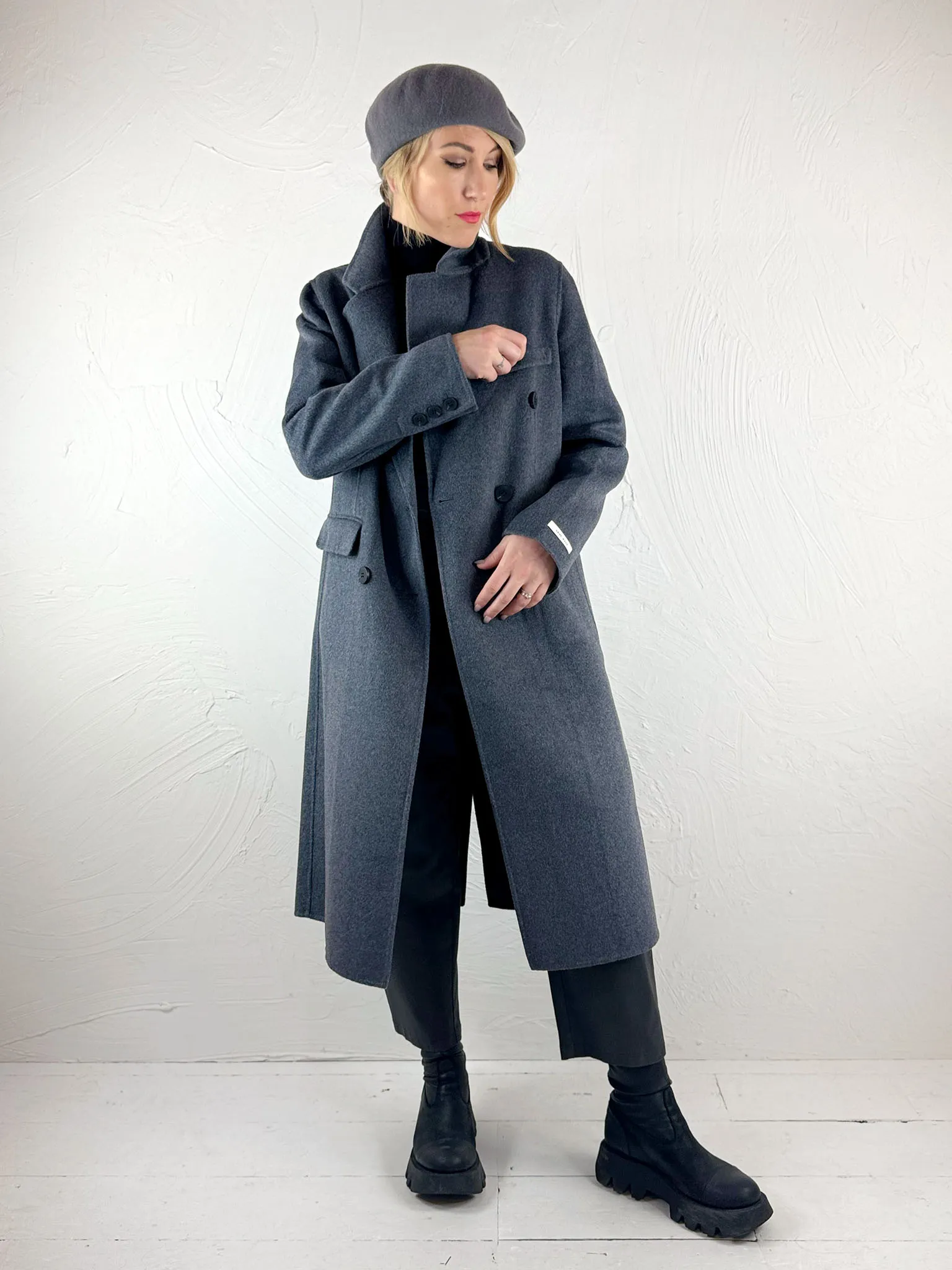 Certainly! To optimize the title for an e-commerce product, its important to include relevant keywords that potential buyers might use when searching, as well as appealing descriptive terms. Here is an optimized title for the Sunny Studio Lou Coat:

Elegant Womens Lou Coat by Sunny Studio – Warm, Stylish, and Versatile Outerwear